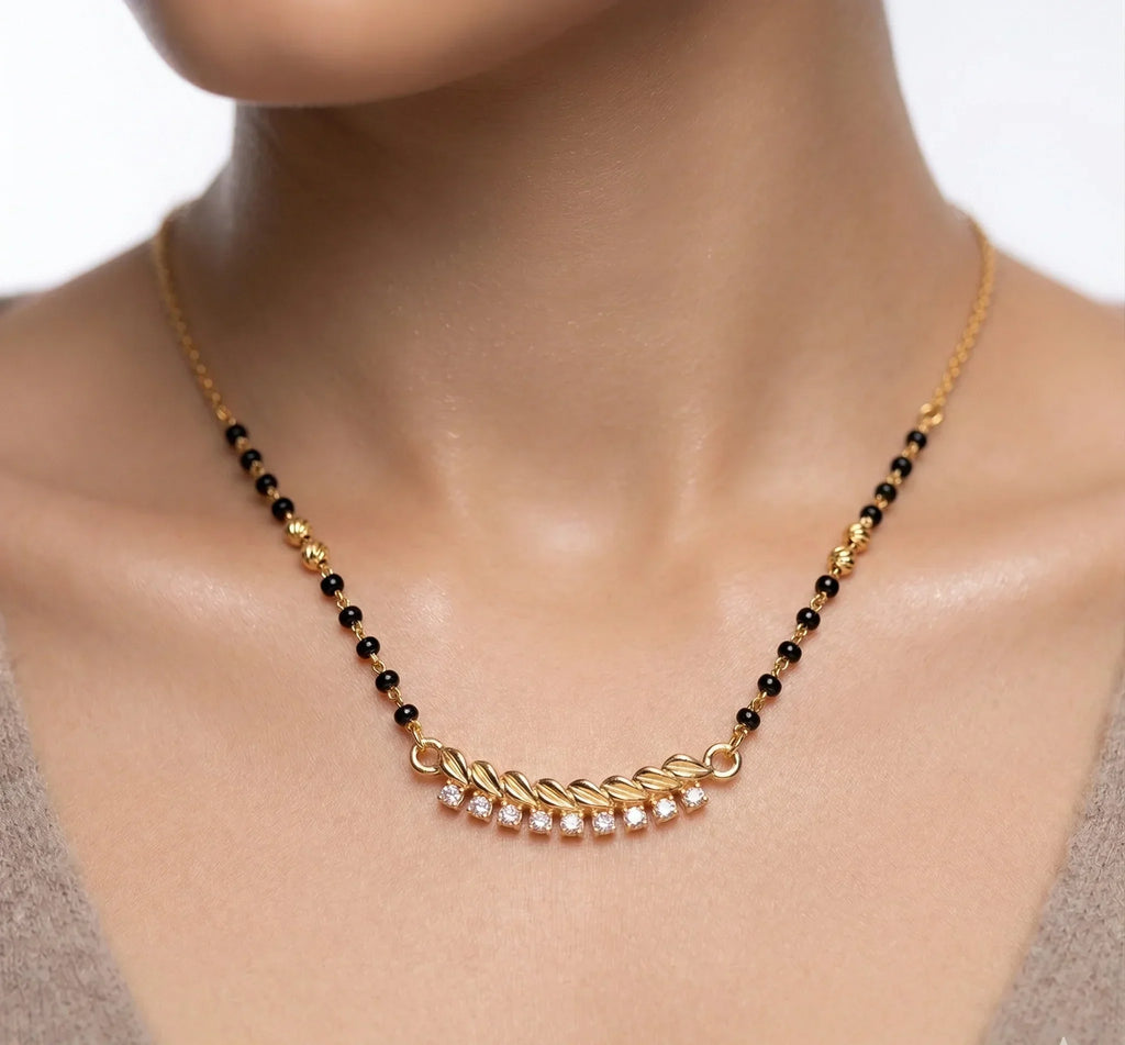 Necklace with black beads and gold accents on a model