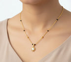 Gold necklace with a pendant on a mannequin