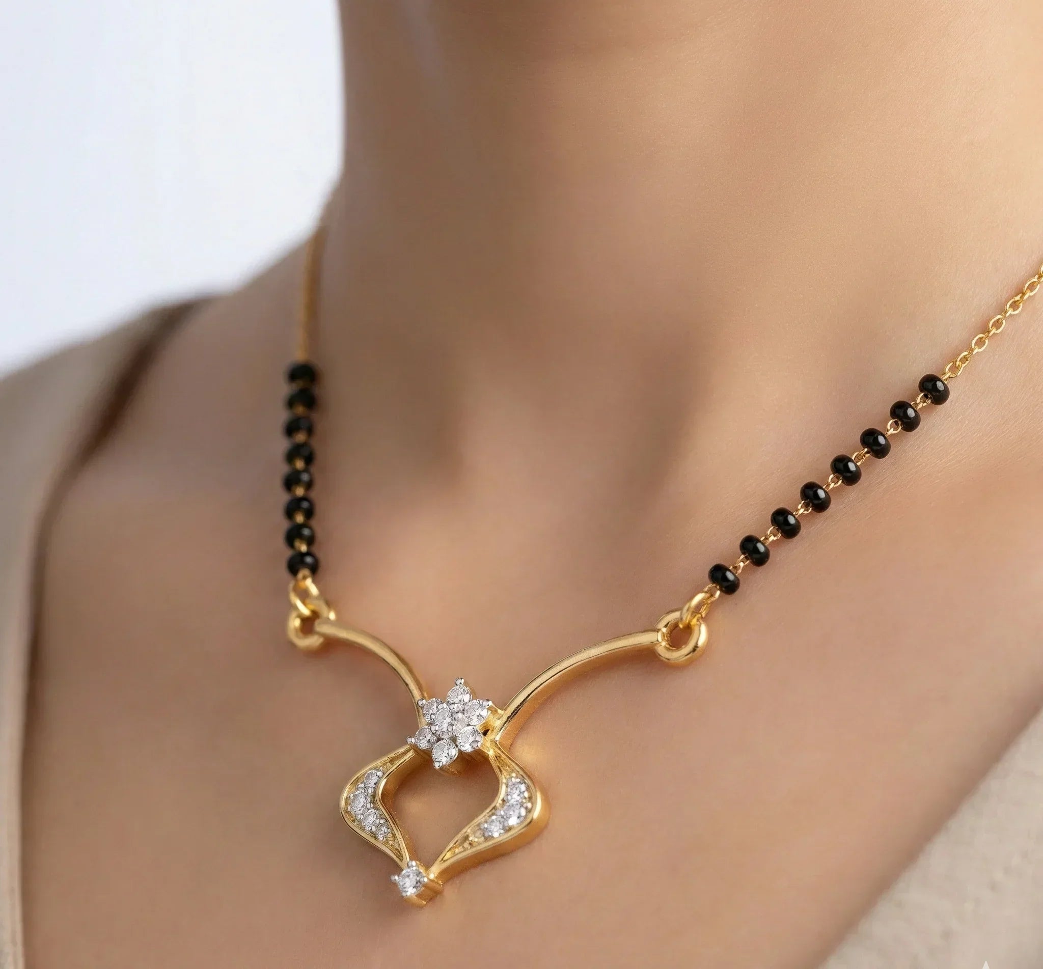 Gold necklace with a heart-shaped pendant on a mannequin