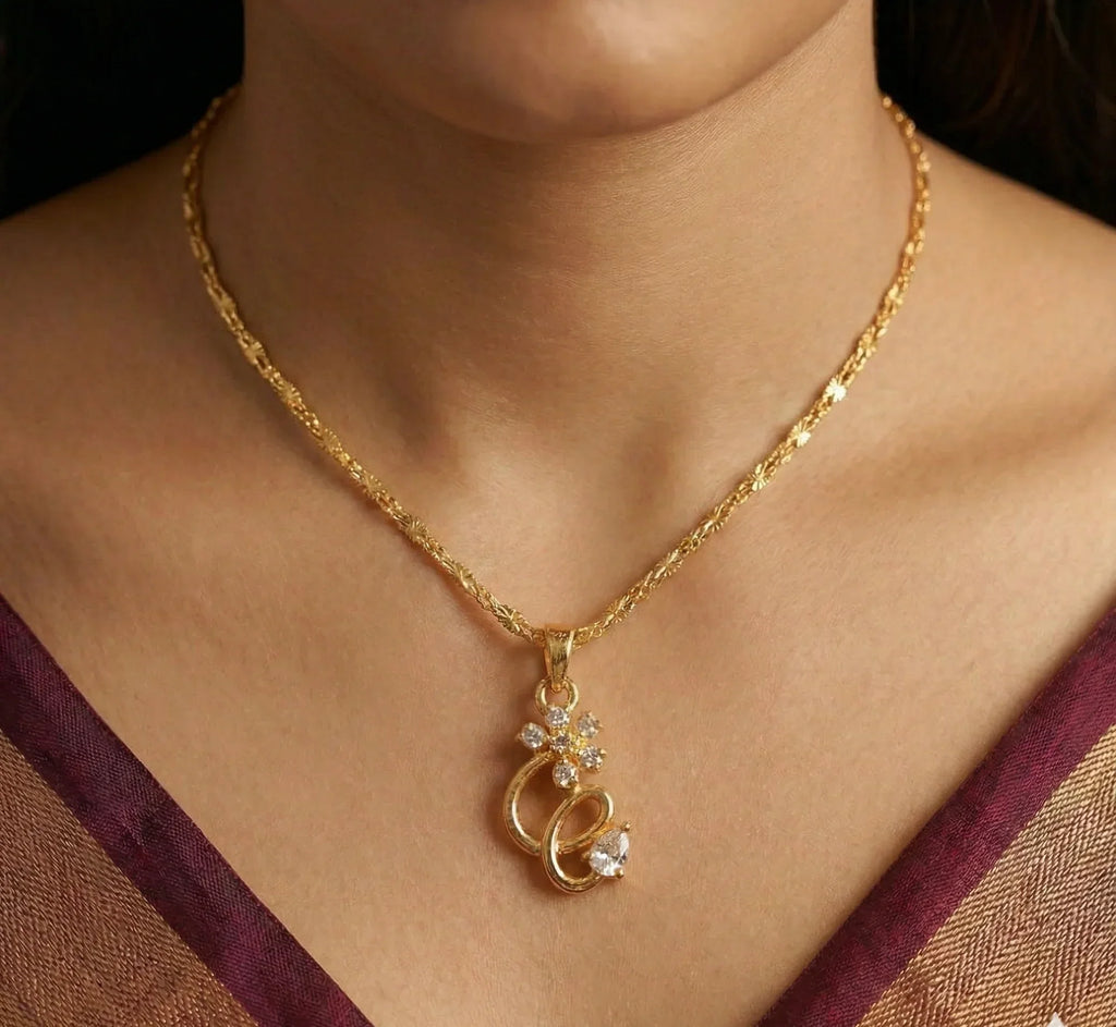 Gold necklace with a pendant worn by a person