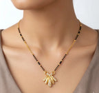 Gold necklace with a pendant on a mannequin