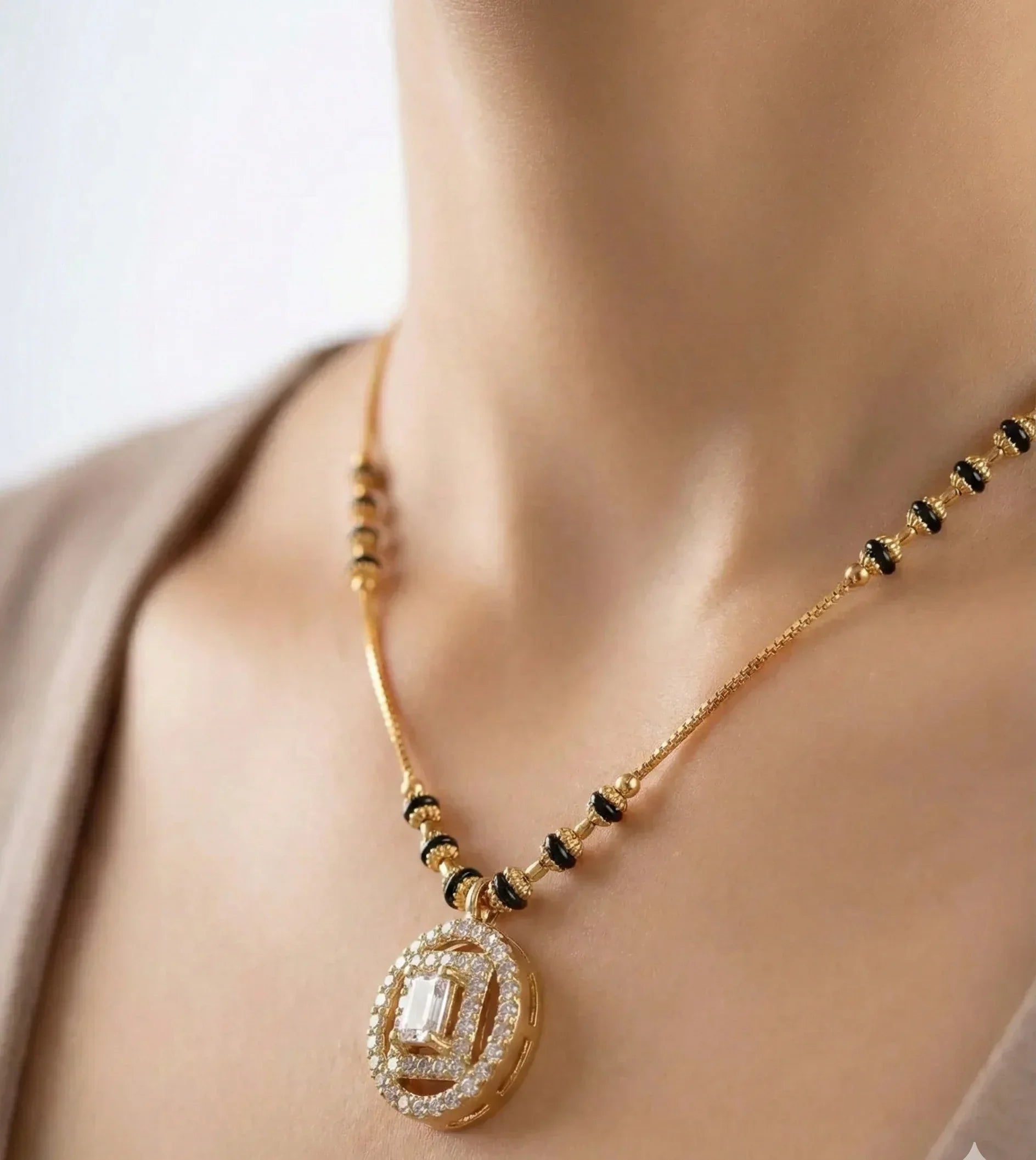 Gold necklace with a pendant on a mannequin