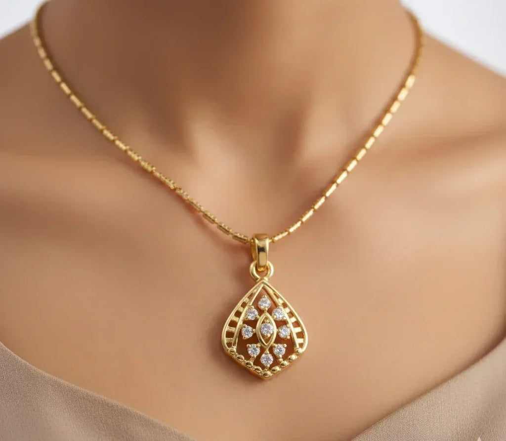 Gold necklace with a decorative pendant on a mannequin