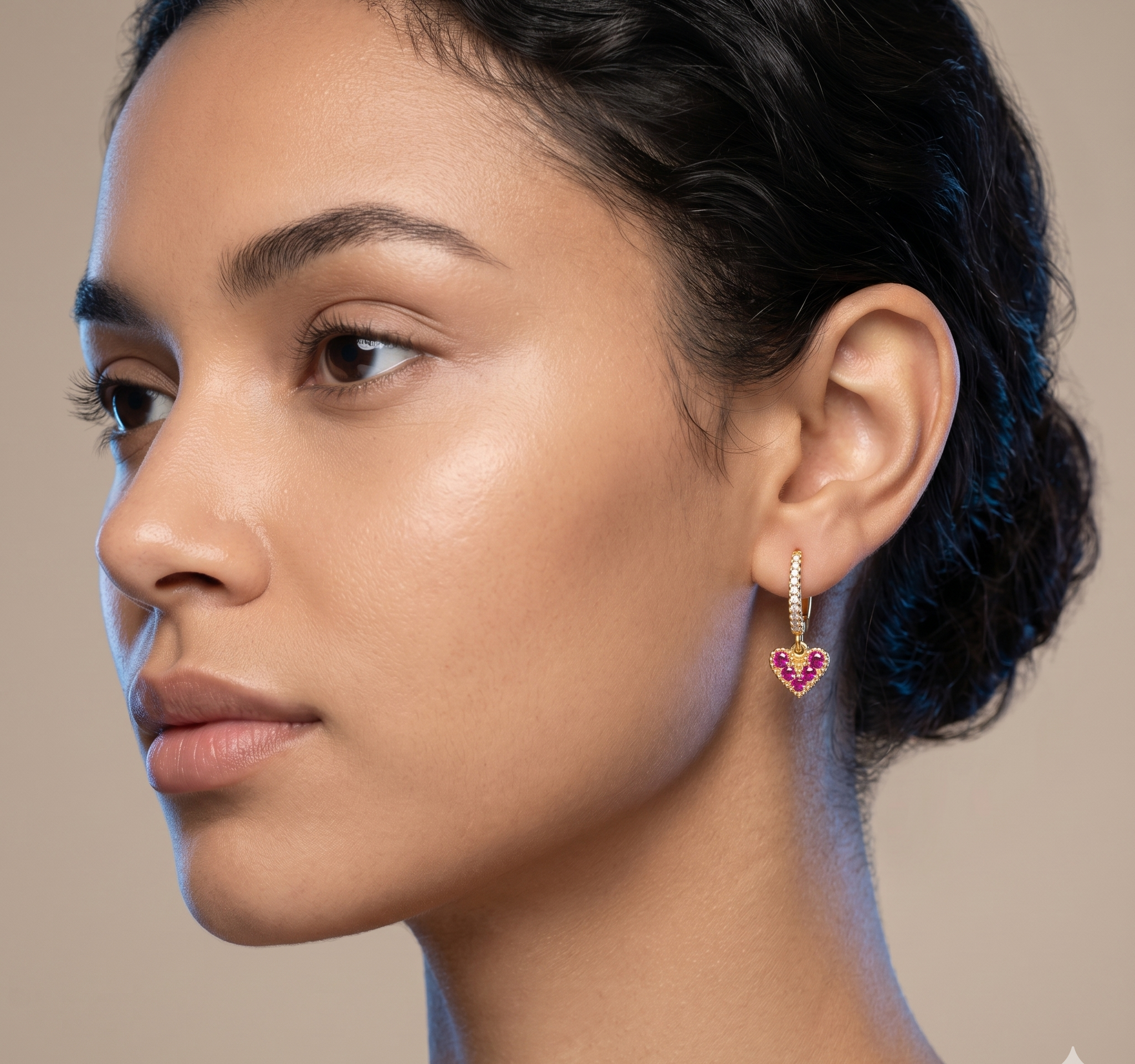 Close-up of a woman wearing a heart-shaped earring with a neutral background