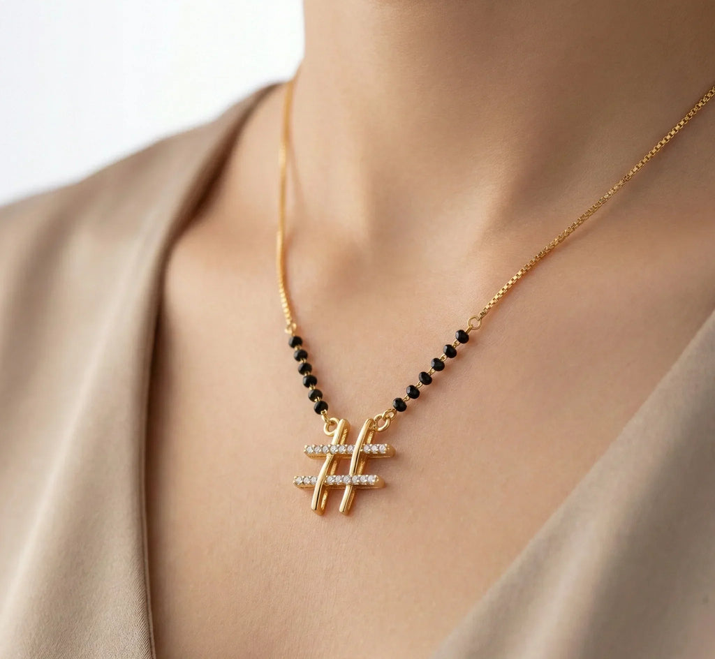 Necklace with gold and black beads on a neutral background