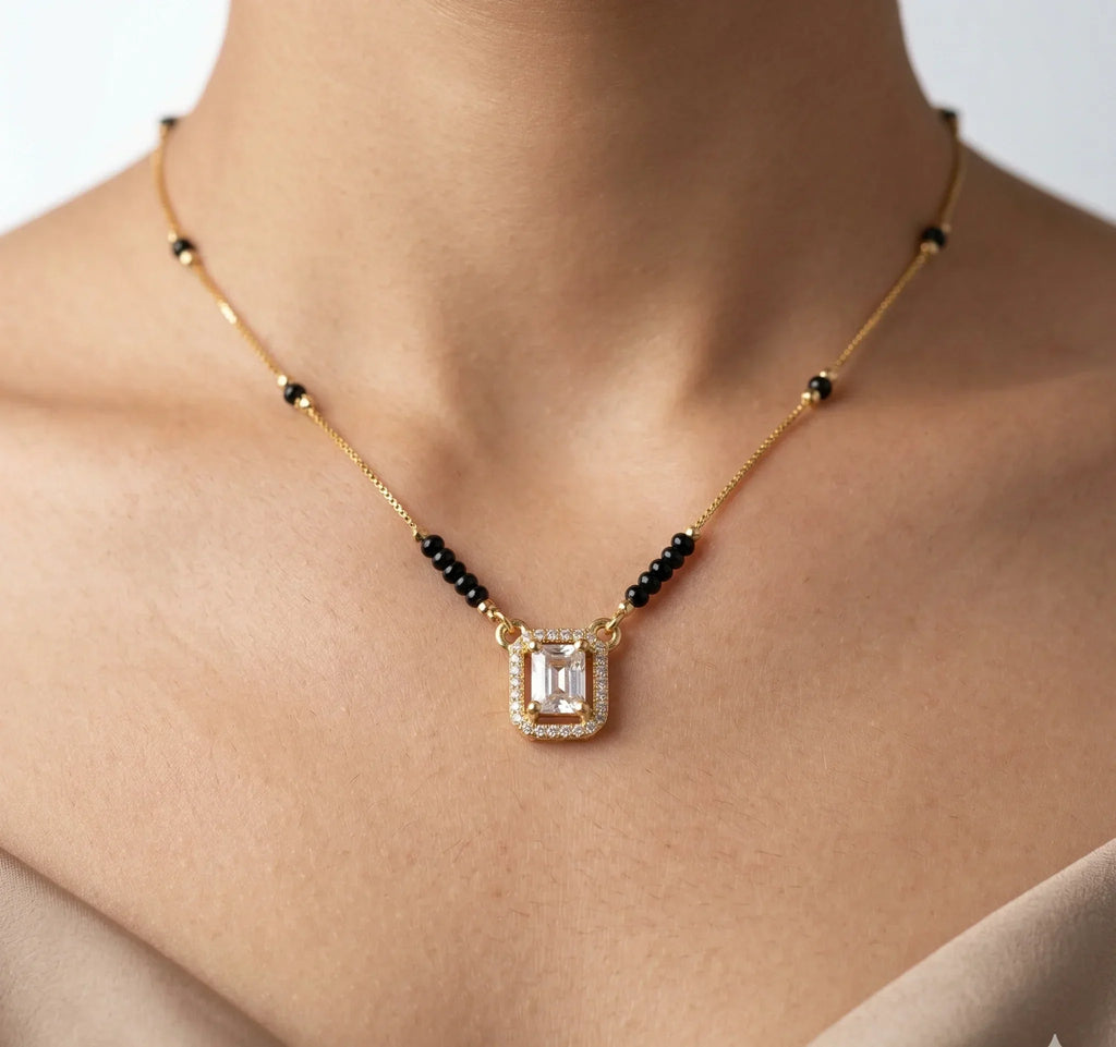 Necklace with a pendant on a person's neck against a neutral background