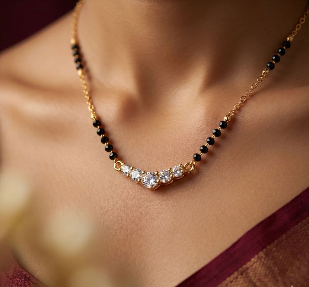 Necklace with black beads and clear stones on a blurred background