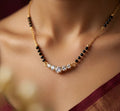 Necklace with black beads and clear stones on a blurred background