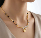 Gold necklace with heart pendant on a mannequin