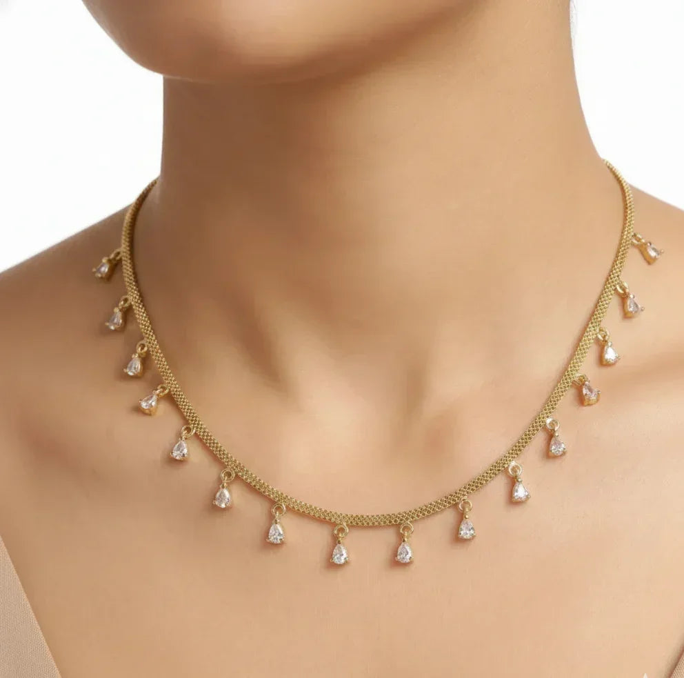 Gold necklace with teardrop-shaped pendants on a mannequin
