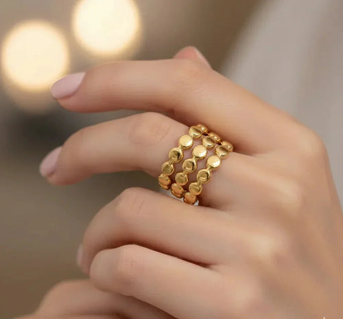 Gold ring on a finger with a blurred background