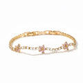 Gold bracelet with floral designs on a white background