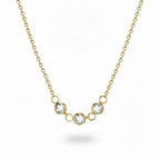 Gold necklace with three crystal pendants on a white background