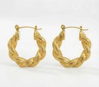 Pair of gold hoop earrings on a white background