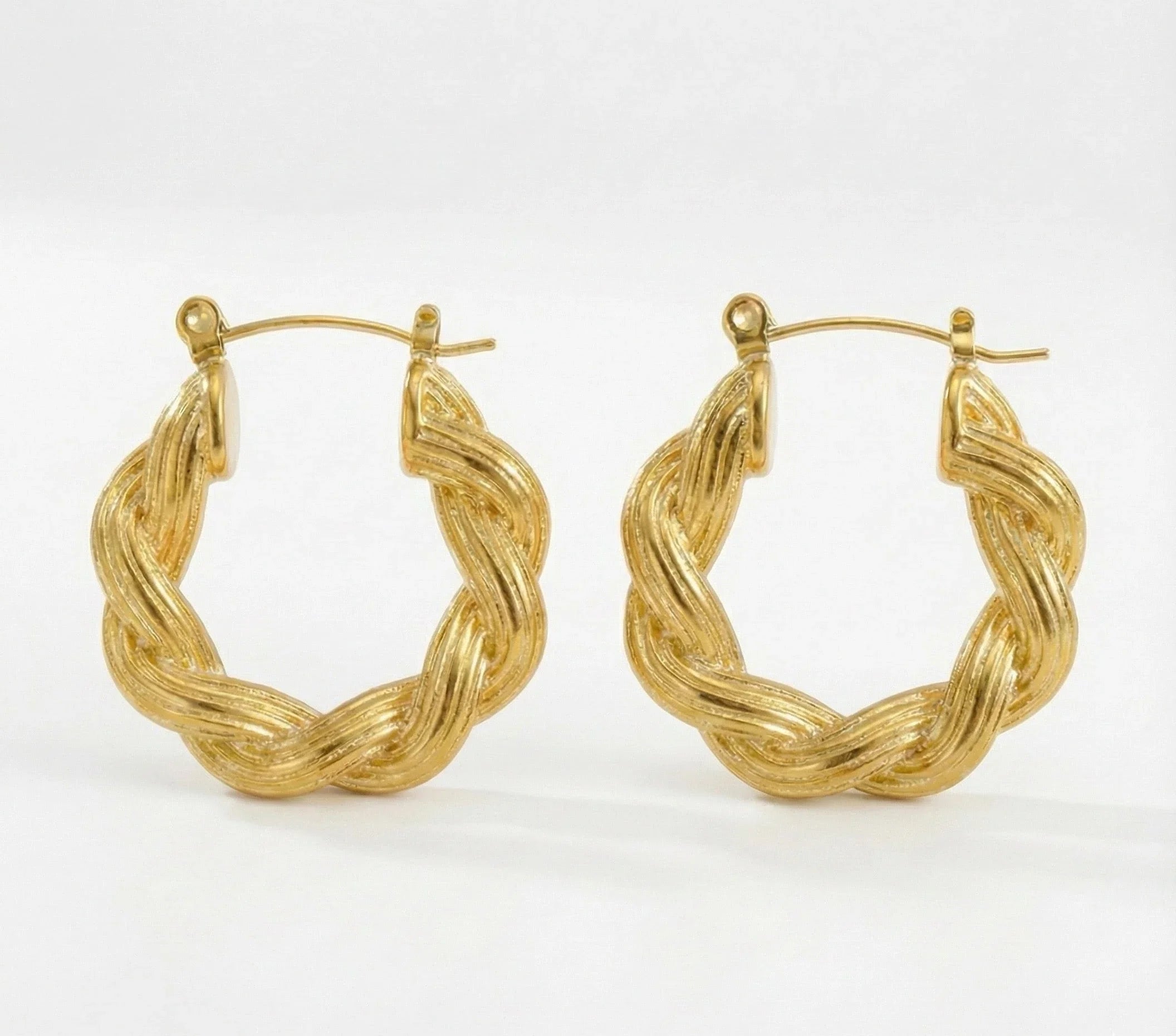 Pair of gold hoop earrings on a white background