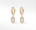 Gold hoop earrings with small circular pendants on a white background