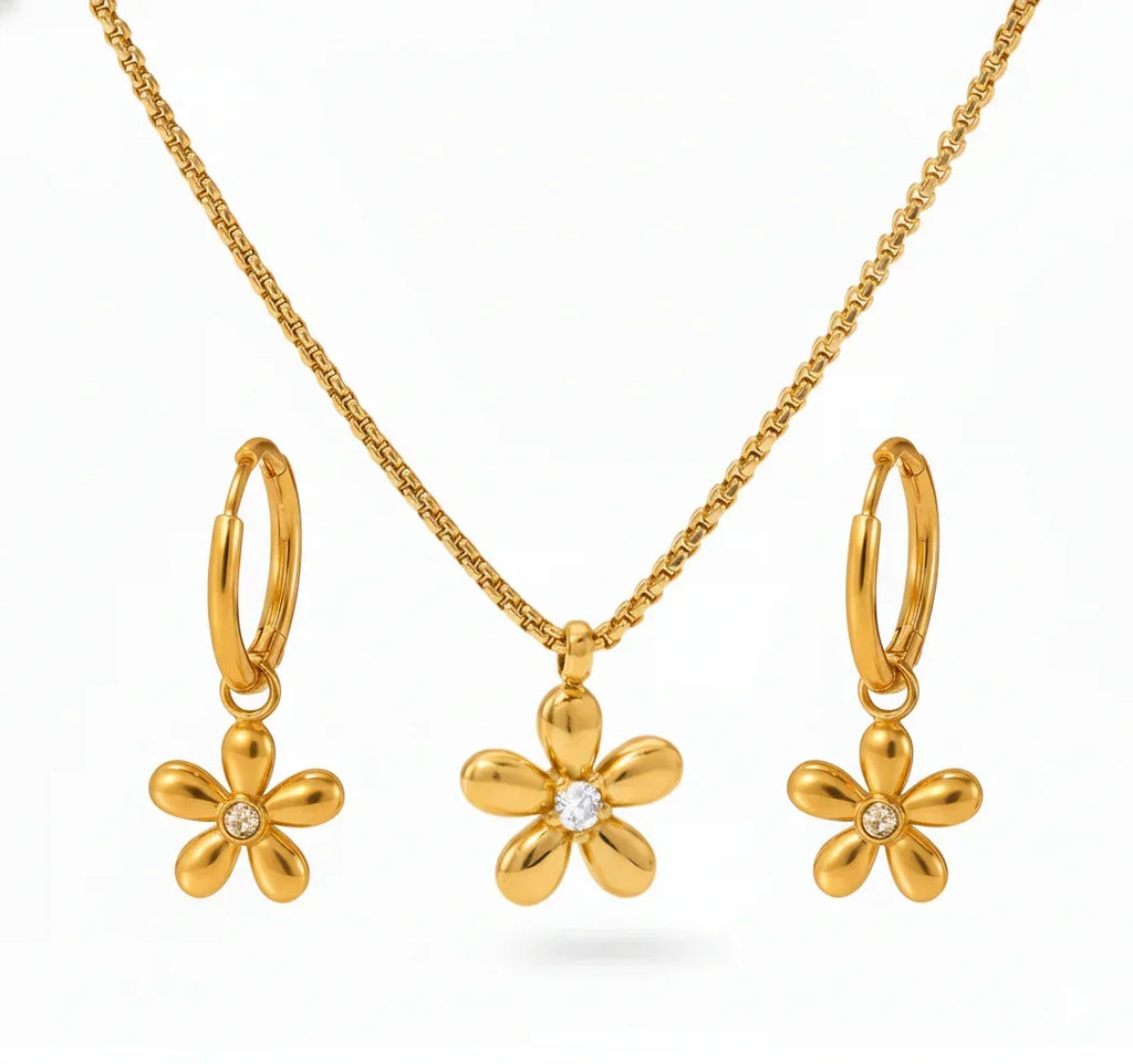 Gold flower-shaped jewelry set with necklace, earrings, and hoop earrings on a white background