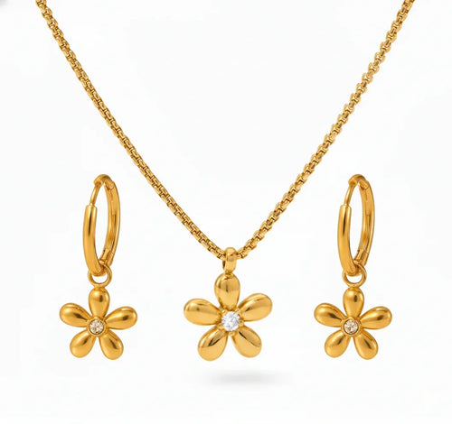 Gold flower-shaped jewelry set with necklace, earrings, and hoop earrings on a white background