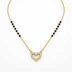 A delicate gold chain necklace featuring a central open heart pendant encrusted with small clear stones, flanked by two rows of small black beads on each side, displayed on a clean white background.